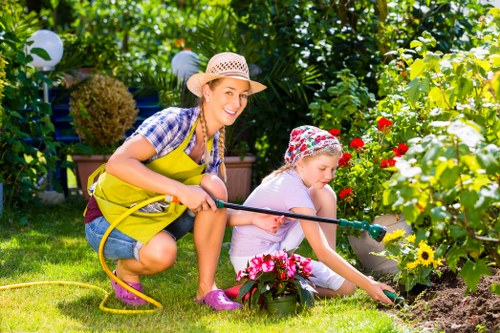Gardener trimming a hedge with professional tools